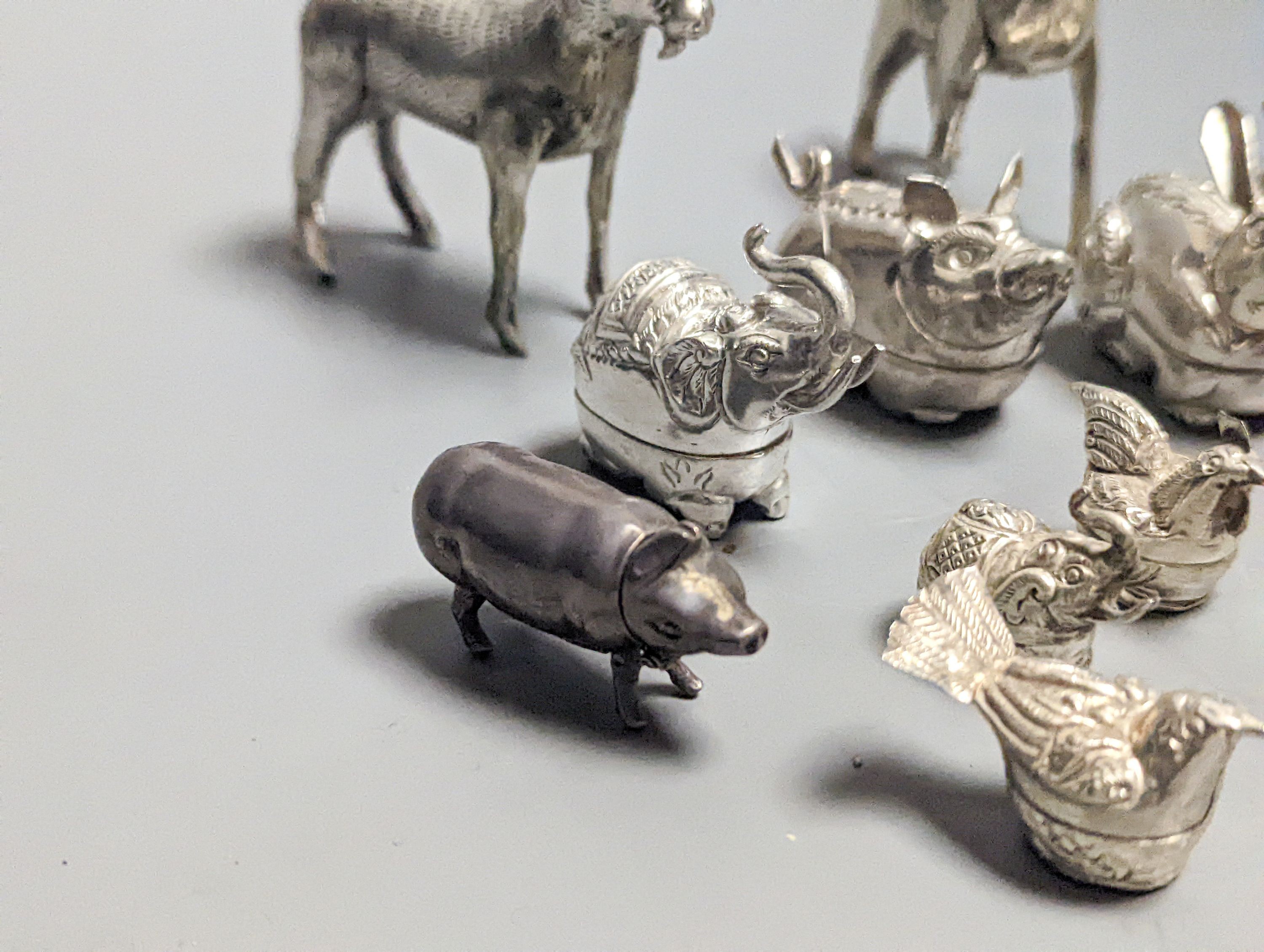 A modern 925 mounted pig pin cushion, 24mm, a similar pig vesta case, four small 925 'hen' boxes and nine base metal animal boxes etc.